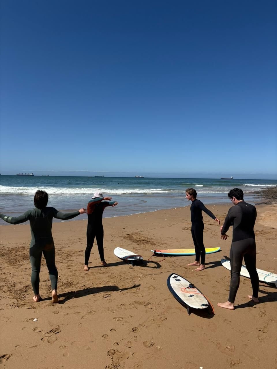 Surf lesson stretch on the beach with boards